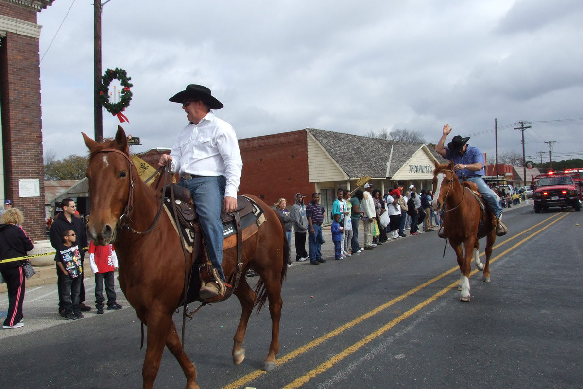 Image: Jerry Glenn and Chad Padilla cater to the crowd while on horseback.