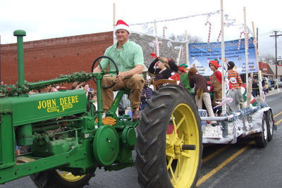 Image: Stephen Janek steers a John Deer tractor while pulling a load of Stafford Student Council members.