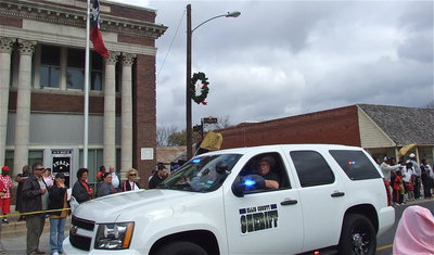 Image: Ellis County Sheriff Johnny Brown offers candy to the parade watchers.
