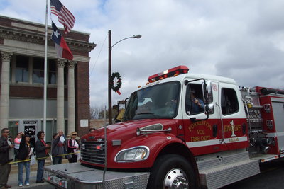 Image: Firefighter Daniel Ballard drives past with the Forreston Fire department.