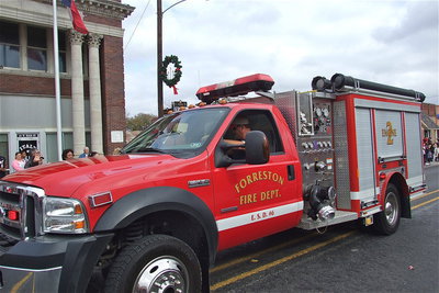 Image: Firefighter Bobby McBride participates during the parade driving a Forreston fire truck.