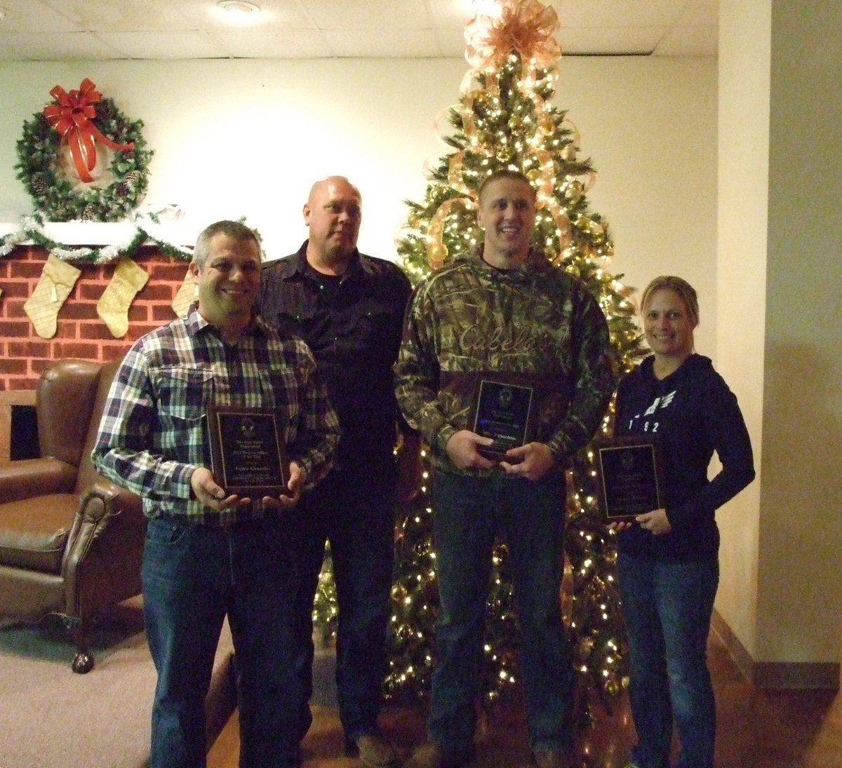 Image: Officer Pedro Gonzalez, Chief Hill, Officer Mike Richardson and Sgt. Tierra Mooney gather at the tree for a commemorative picture.