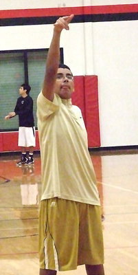 Image: Jorge Galvan gets in the groove from the foul line before the JV game between Italy and West.