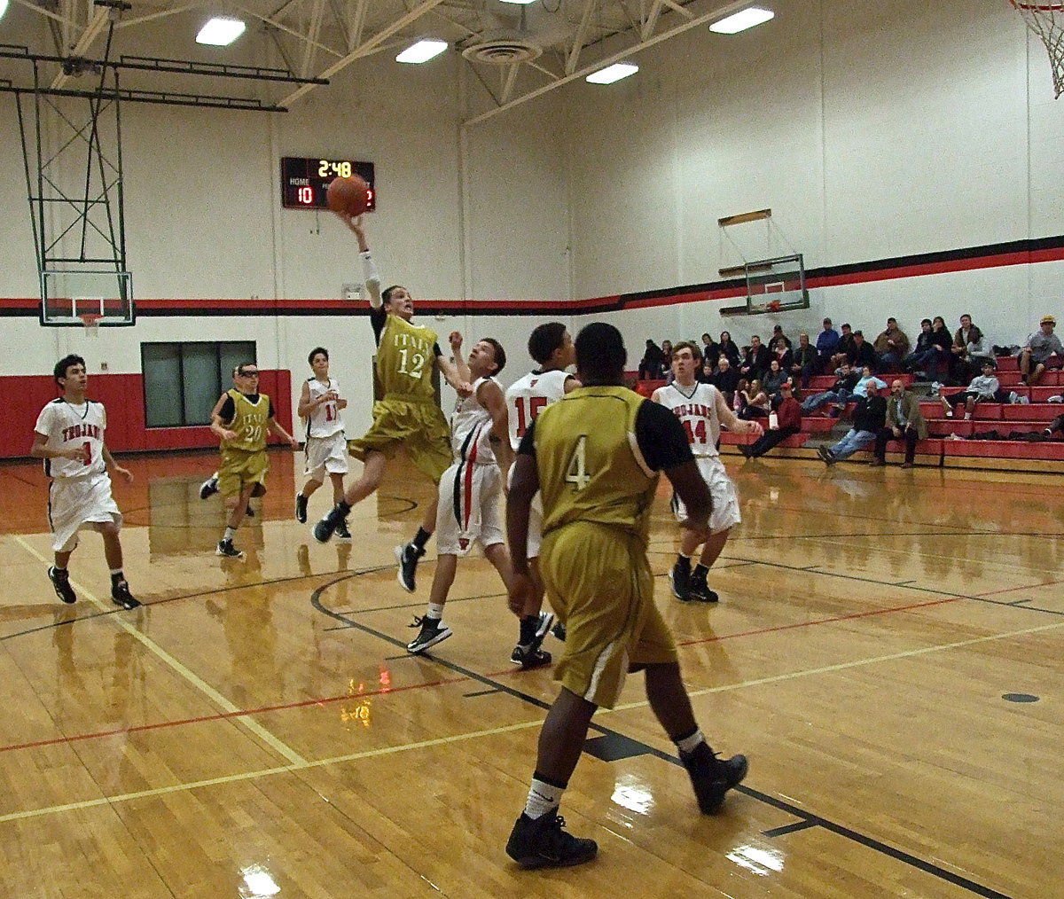 Image: Ty Windham(12) tries to dunk it from the free-throw line as teammate Billy Moore(4) moves in for the rebound, just in case, during a JV matchup between Italy and West.