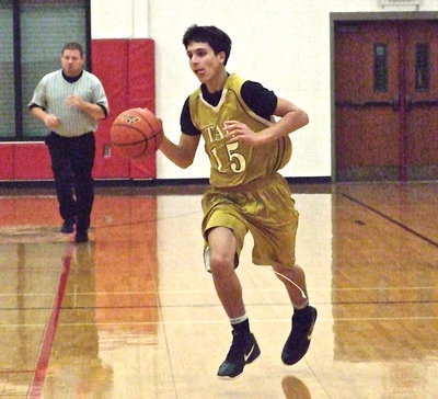 Image: Mason Womack(15) pushes the ball up the court.