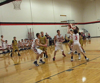 Image: Point guard John Escamilla(3) powers his way into the lane against West.