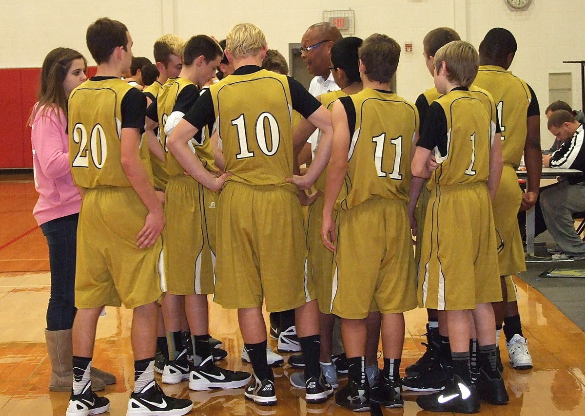 Image: JV Gladiator head coach Larry Mayberry, Sr. inspires his players who are playing better and better with each quarter.