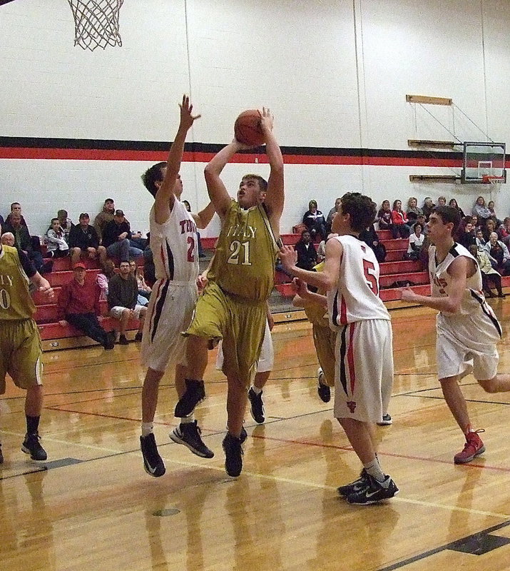 Image: Zain Byers(21) goes for a thunderous layup attempt against West.