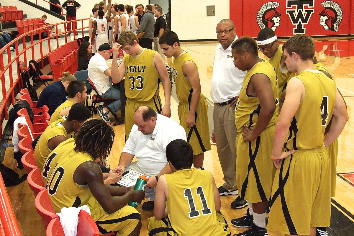 Image: With Italy in the early stages of their basketball season and searching for answers against the West Trojans, first-year Italy head coach Brian Coffman draws up a play during a timeout.