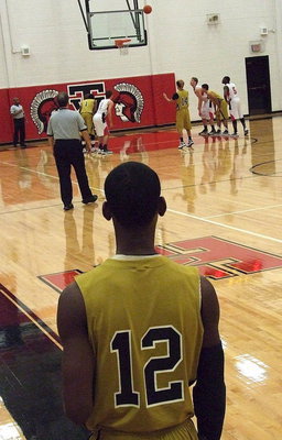Image: Gladiator Eric Carson(12) observes the action during a break as teammate Kelvin Joffre(14) attempts a free-throw.