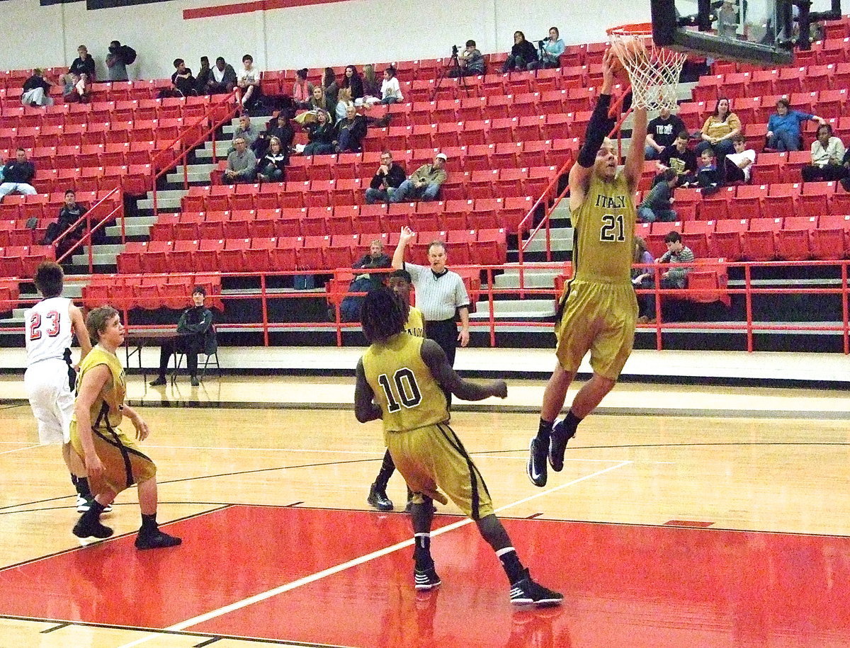 Image: Cole Hopkins(21) soars for a rebound as Bailey Walton(33), Ryheem Walker(10) and Eric Carson(12) release downcourt.