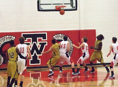 Image: Eric Carson(12) swishes in a 3-pointer over a West defender.