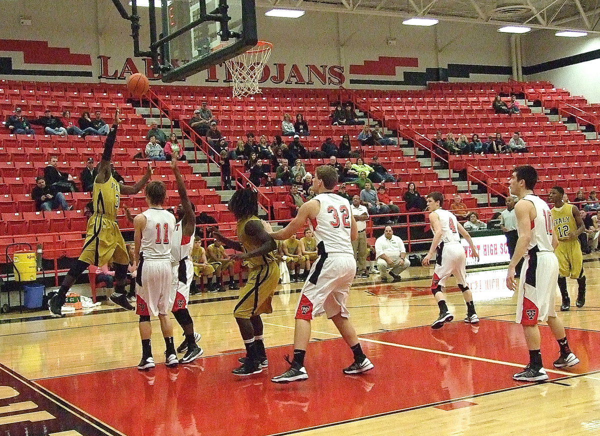 Image: Marvin Cox(3) tries to wrap around a pair of West defenders as Ryheem Walker(10) gets inside postion for the rebound.