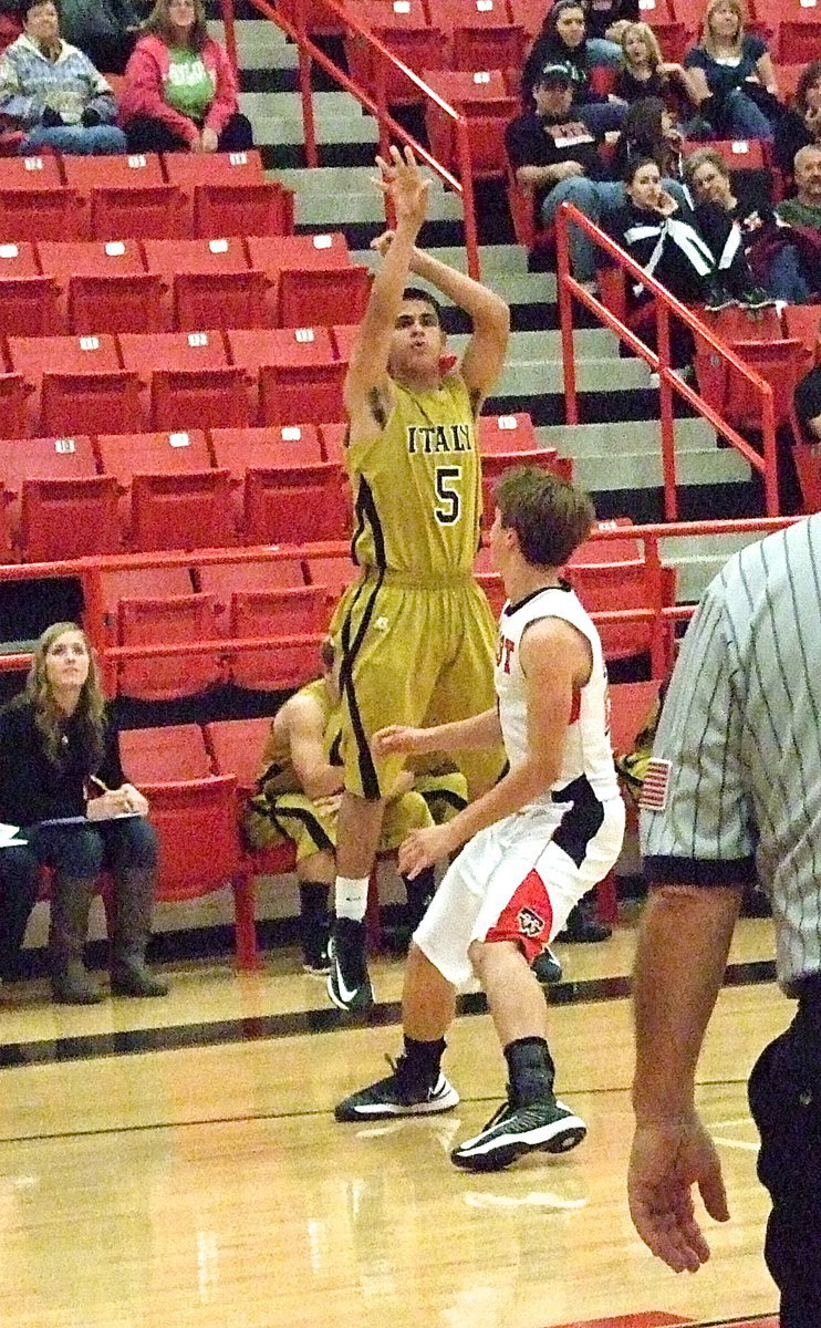 Image: Reid Jacinto(5) releases a three-ball over the West defense.