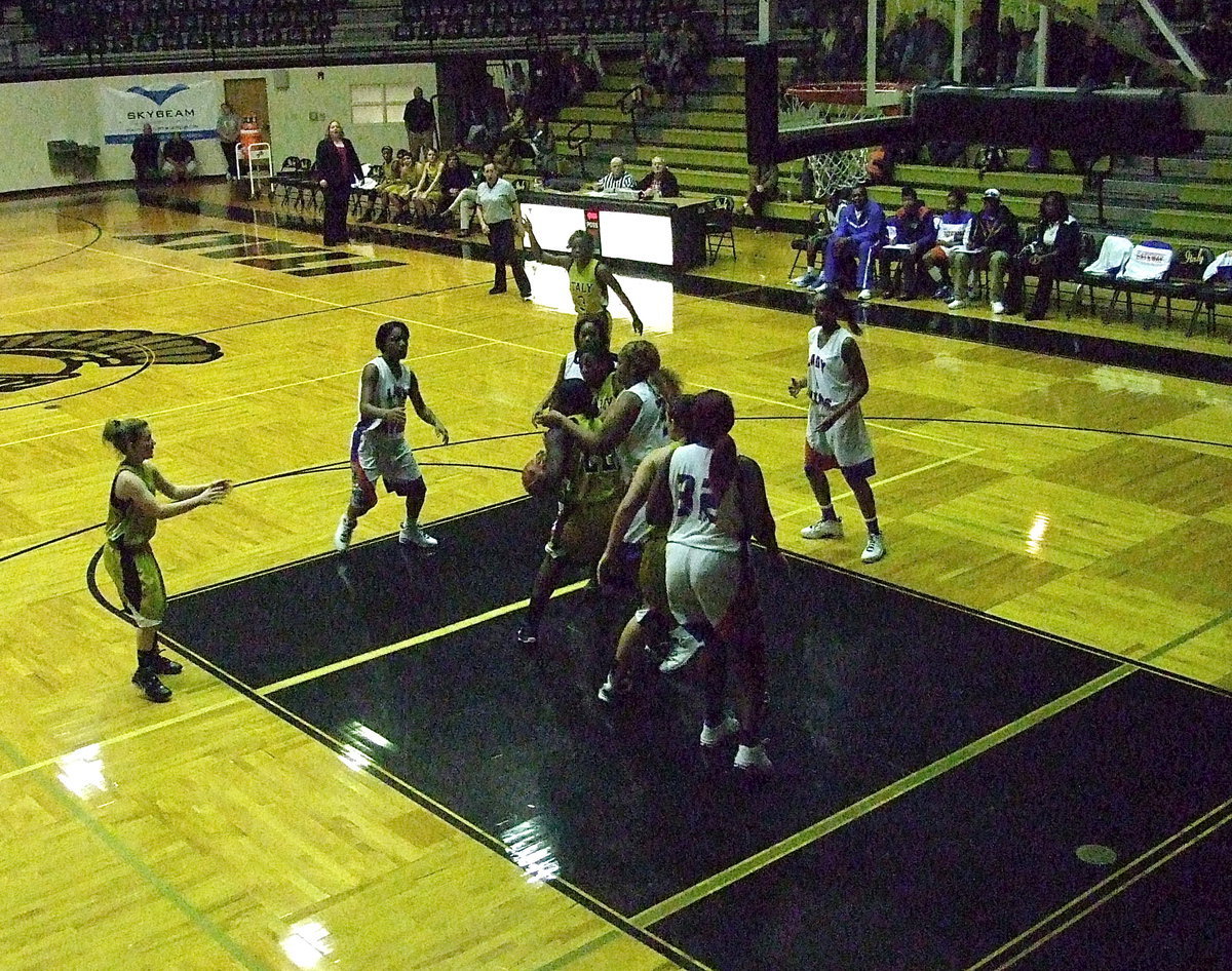 Image: Taleyia Wilson(22) secures a rebound while being swamped by Lady Gator defenders.