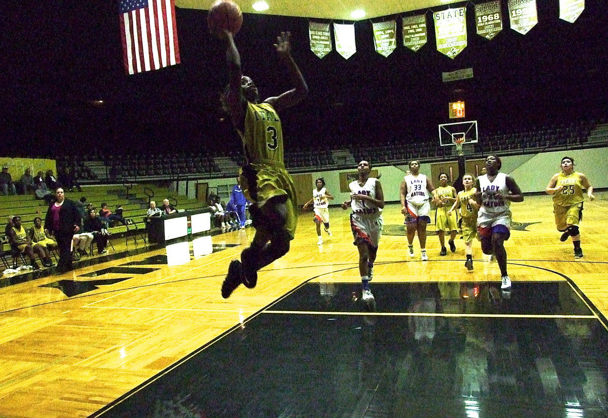 Image: High-flying Kortnei Johnson(3) helps finish off the Dallas Gateway Gators 61-43 to help the Italy Lady Gladiators begin district with a 2-0 record. Johnson put in a season high Tuesday night with 32-points.