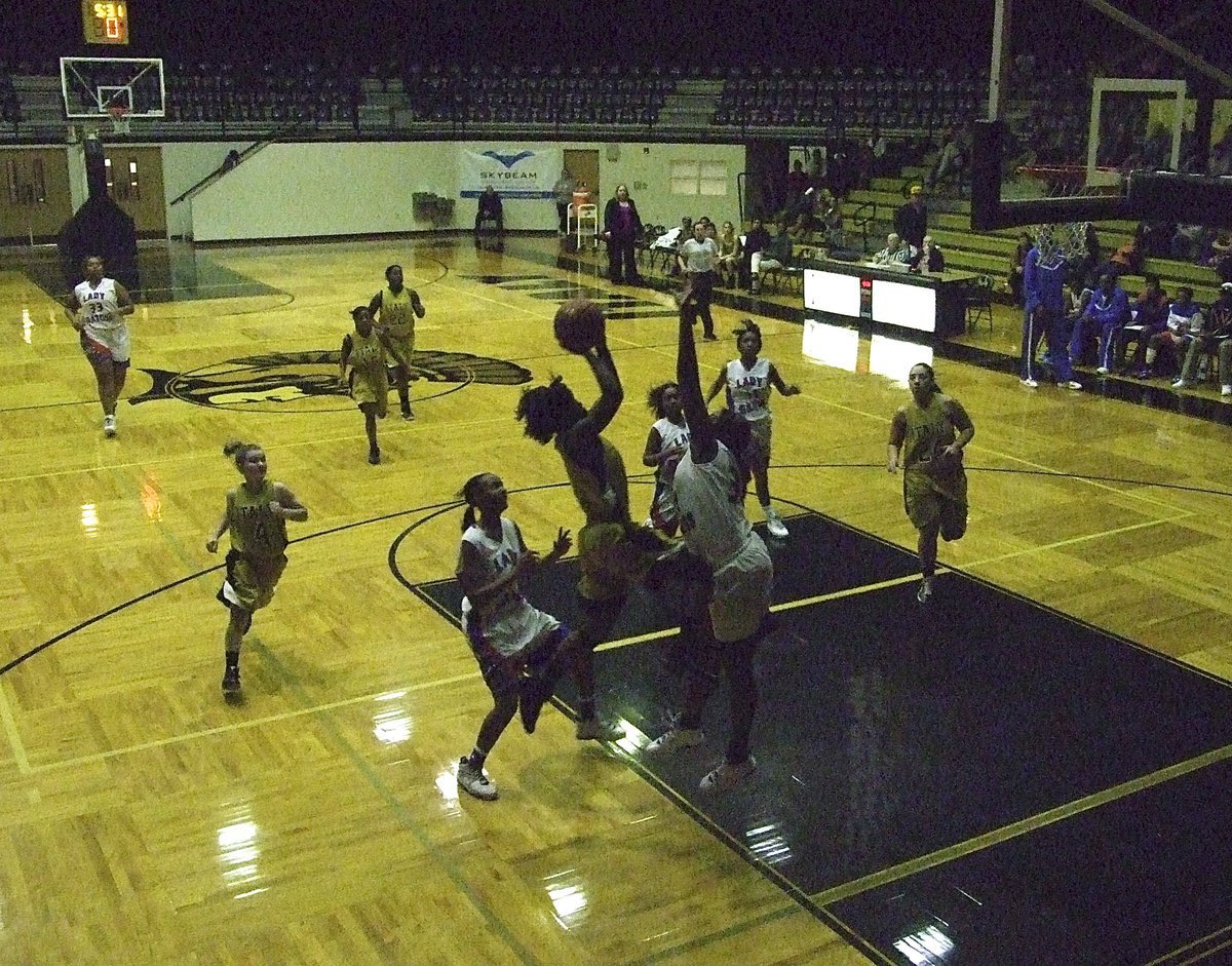 Image: Lady Gladiator Kortnei Johnson(3) silhouettes her way to the rim.