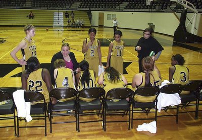 Image: Head coach Melissa Fullmer and assistant coach Tina Richards school their ladies on game strategies during a timeout.