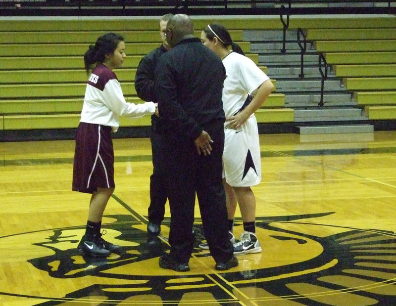 Image: Arlington Summitt Captain, Raechell #11, meets with refs and captain of the Lady Gladiator team, Alyssa Richards #24 during the pre-game.