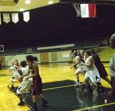 Image: Lady Gladiators battle the Lady Skyhawks until the end with #3 Kortnei Johnson securing a defensive rebound.
