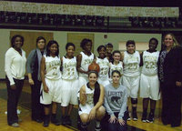 Image: 2012-2013 Lady Gladiators and coaches take a moment to pose for the first district win.
