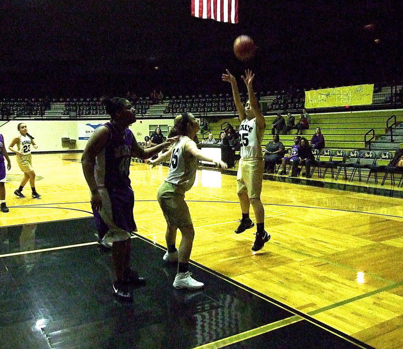 Image: Brooke DeBorde(15) clears some room for teammate Elizabeth Garcia(25) to try a bank shot over the Marlin defense.