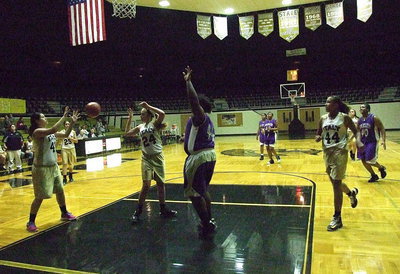 Image: Annie Perry(24) flips a pass over to teammate Jenna Holden(41) who has a better look at the basket.