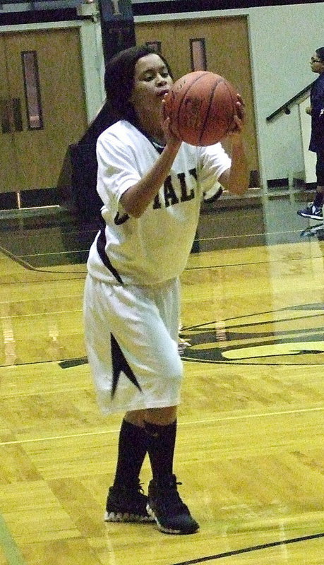 Image: Lady Gladiator Alex Minton tries a 3-pointer during the pre-game warmup.