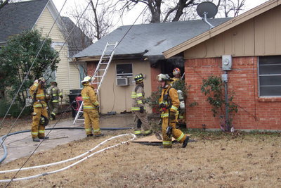 Image: Firefighters remove debris and deal with remaining hot spots.
