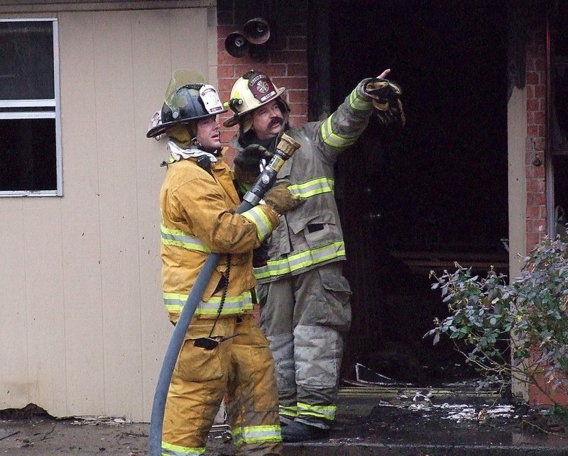 Image: Milford’s Fire Chief points out a hot spot to spray down with water to Italy Firefighter Paul Cockerham.