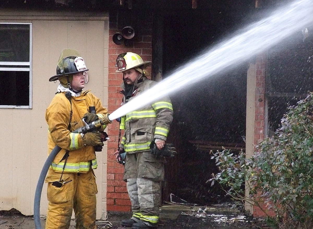 Image: I.F.D. Engineer Paul Cockerham saturates the area.