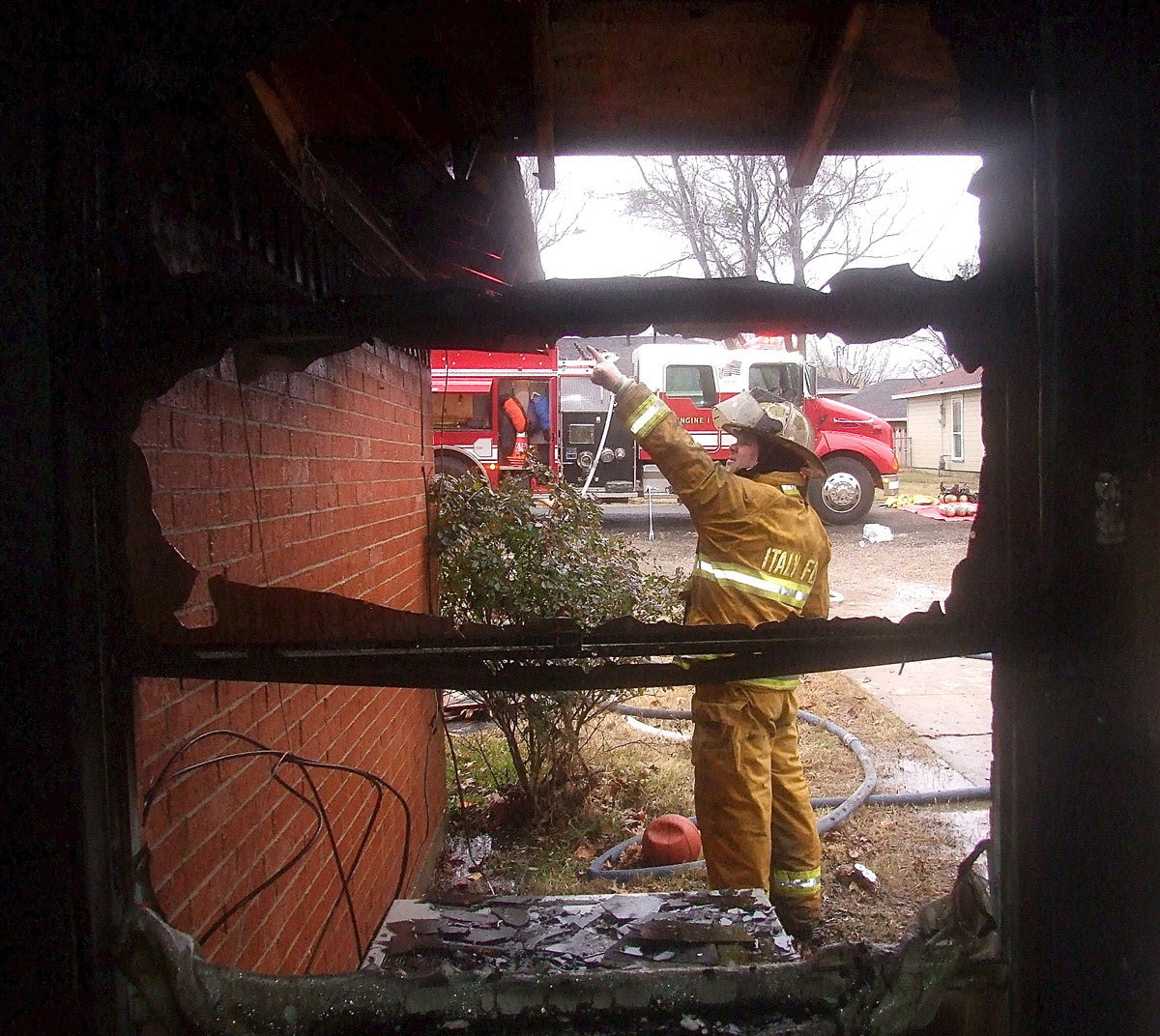 Image: Italy Firefighter Jackie Cate wants to double check the roof line.