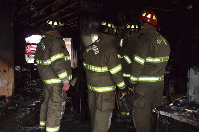 Image: The Milford fire crew analyzes the source of the fire.