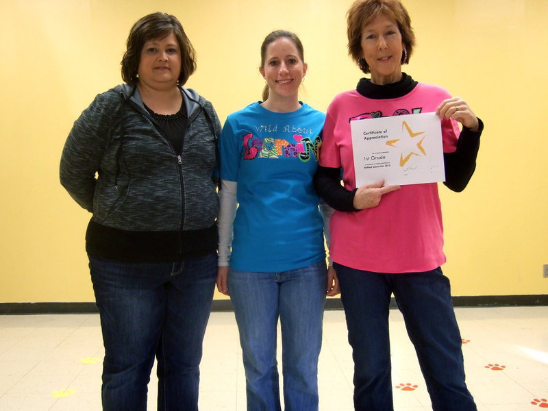 Image: Mrs Jacinto, Mrs. McCleskey and Mrs. Morgan (first grade teachers) were presented an award for their classes participating in science projects in the class room preparing for when then are old enough to participate in the Science Fair.