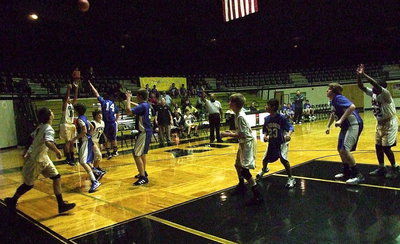 Image: Tylan Wallace(10) drops in a 3-pointer form the right corner using a screen from Cade Roberts(12).
