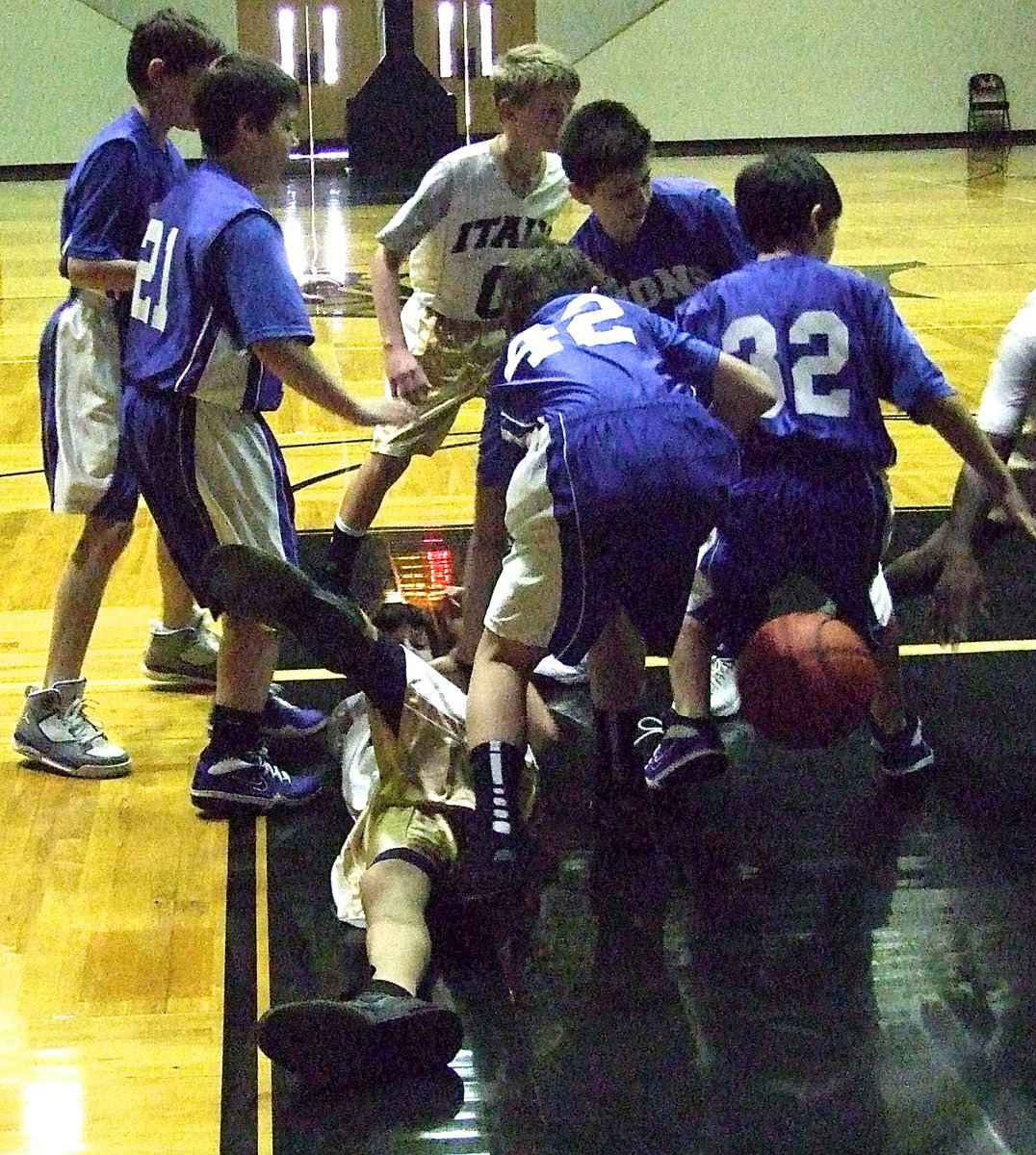 Image: Getting sawdusty is Ty Hamilton(4) as he and teammate Garrett Janek(0) battle for the loose ball.