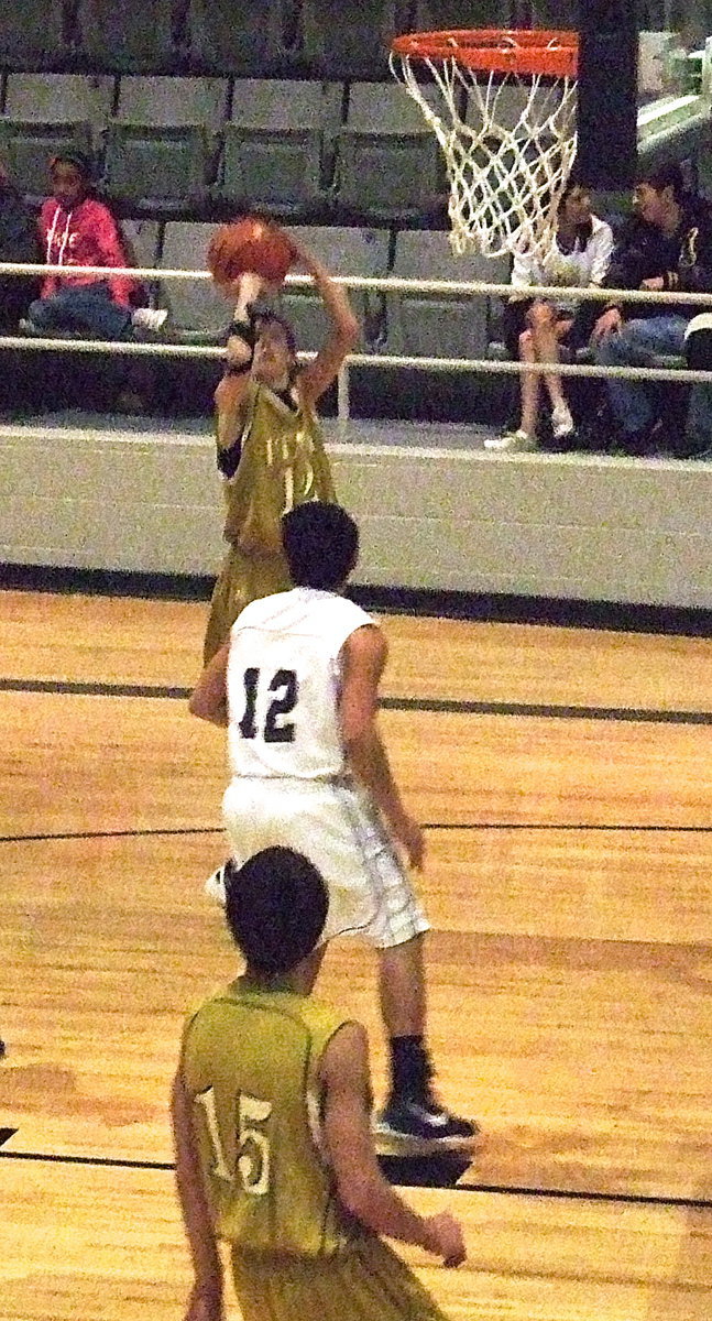 Image: Ty Windham(12) rises for a jump shot as Mason Womack(15) moves into rebounding position.