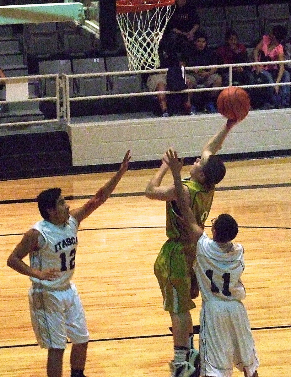 Image: JV Gladiator John Escamilla(3) attacks the rim against Itasca.