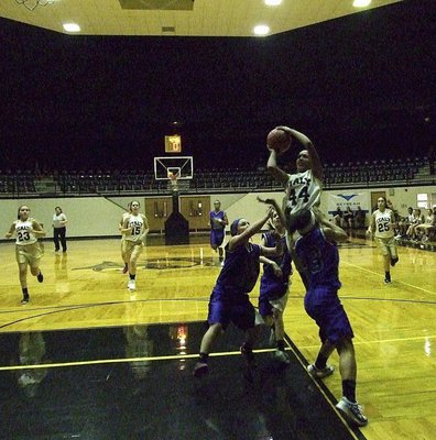Image: Emmy Cunningham(44) rises above three Blooming Grove defenders to draw a shooting foul.