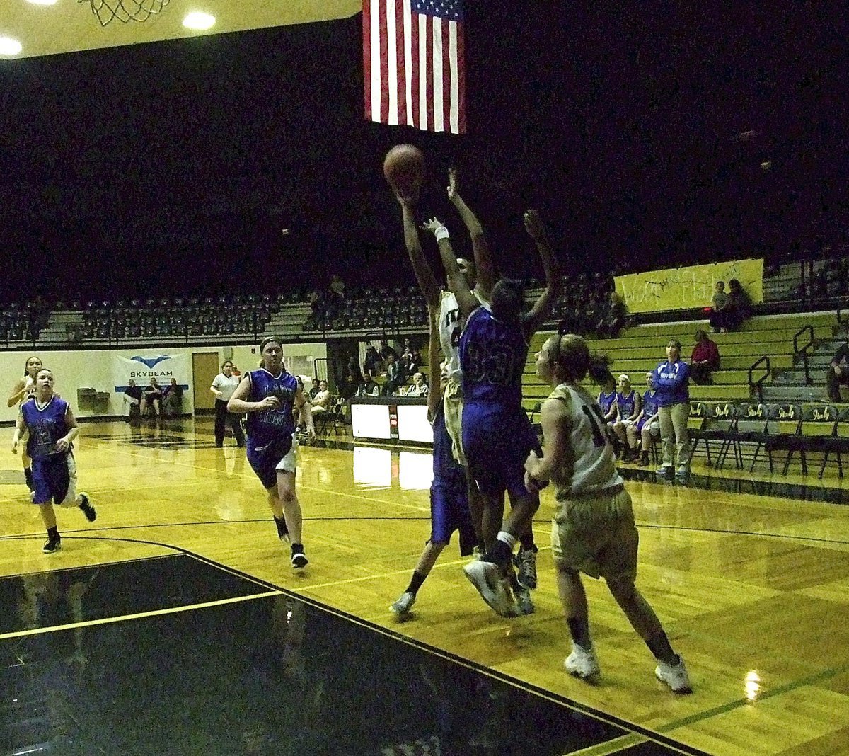 Image: Emmy Cunningham(44) skies for the rim as Brooke Deborde(15) turns to rebound.