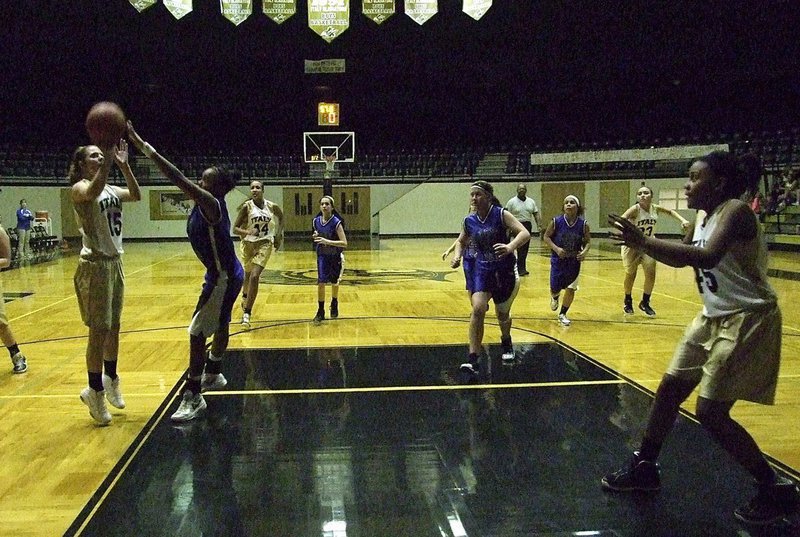 Image: Brooke DeBorde(15) puts up the shot with Charisma Anderson(45) in good position to rebound.