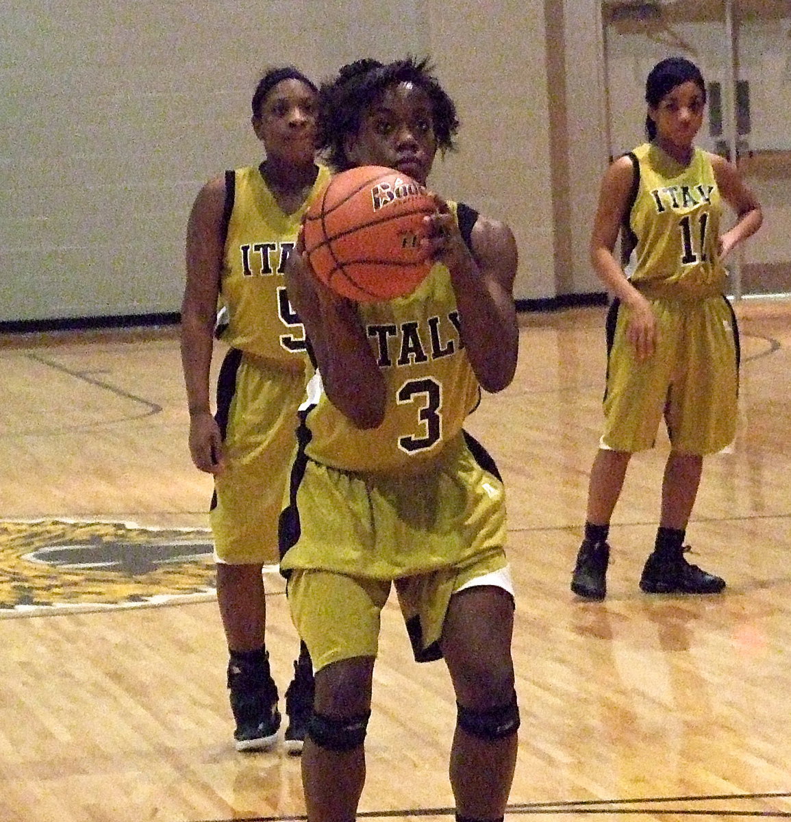 Image: Jameka Copeland(5) and Ryisha Copeland(11) look on as teammate Kortnei Johnson(3) tries her luck at the free-throw line.