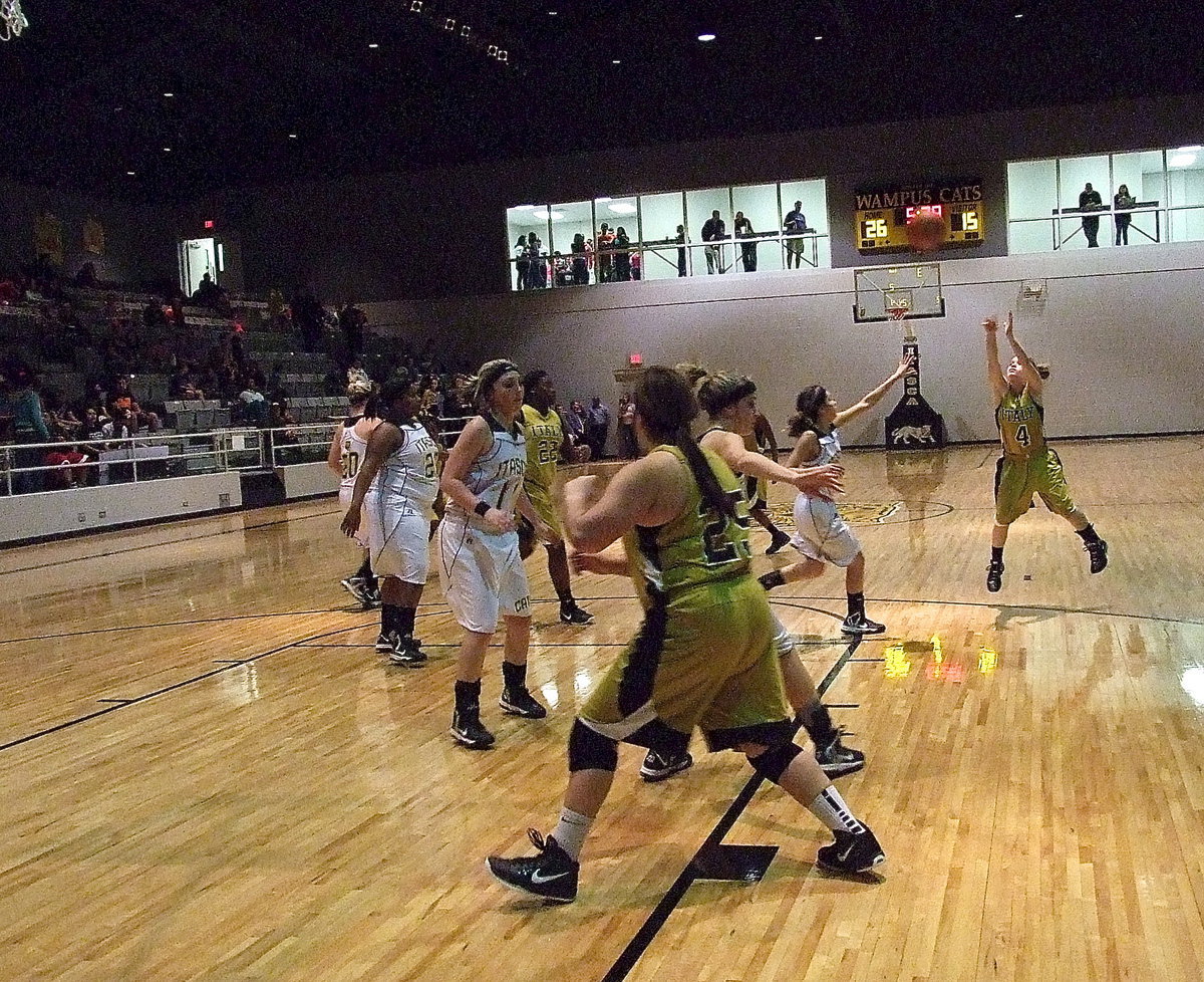 Image: Tara Wallis(4) fires from deep as teammate Monserrat Figueroa(25) claims inside position for the rebound.