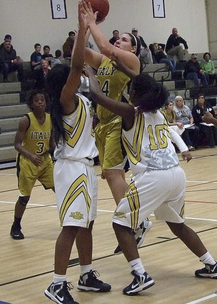 Image: Senior Lady Gladiator Alyssa Richards(24) rises over Lady Stallion defenders.