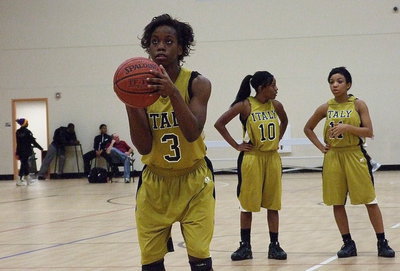 Image: Cousins Kendra Copeland(10) and Ryisha Copeland talk basketball as teammate Kortnei Johnson(3) prepares to fire a free shot.