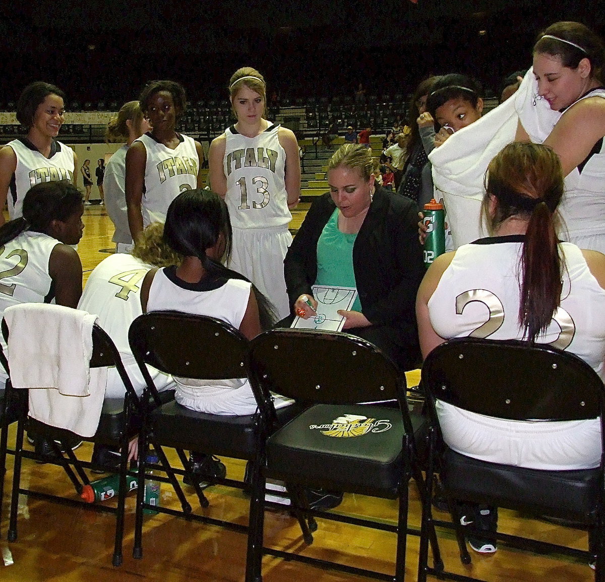 Image: Lady Gladiator head coach Melissa Fullmer talks with her players during a timeout as Italy wins their final home game before the playoffs, 41-23 over Itasca.