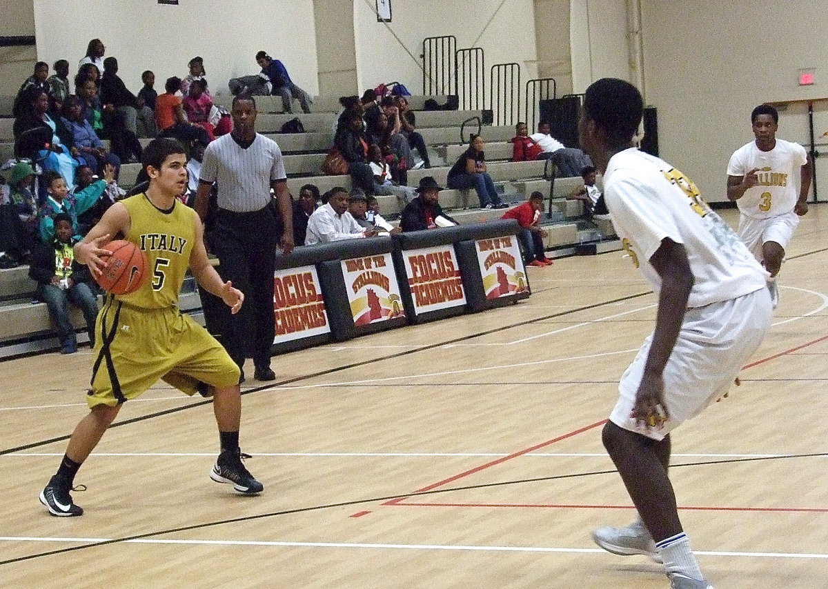 Image: Senior Gladiator Reid Jacinto(5) handles the ball while checking inside for a chance to pass.