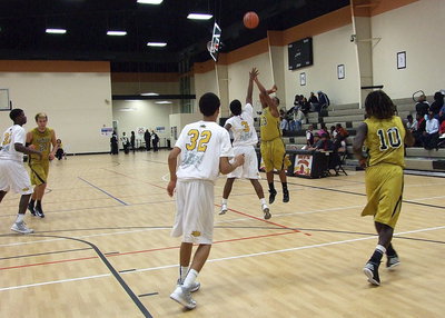Image: Darol Mayberry(13) knocks down a 3-pointer over a Stallion defender.