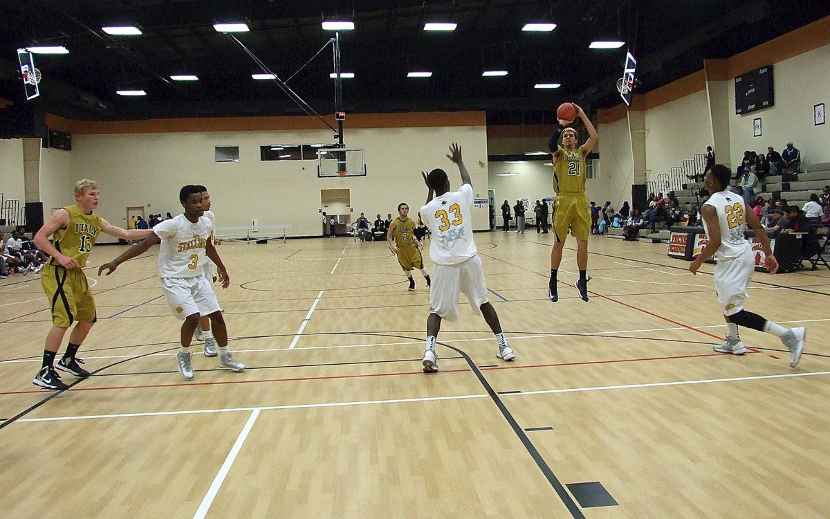 Image: He may only be an inch tall in this photo, but trust me, Cole Hopkins(21) is 6’,8" tall as he rises to knock down a 3-pointer against the Stallions.