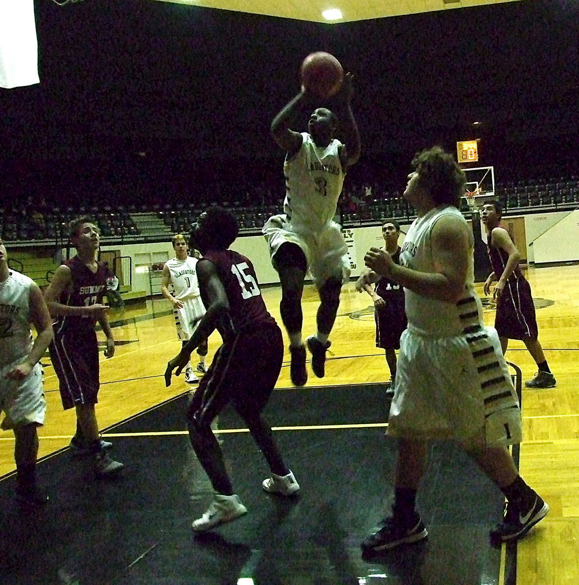 Image: Italy’s Marvin Cox(3) drives into the middle of the lane against Skyhawk with teammate Kevin Roldan(33) in position to rebound.